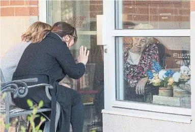  ?? RICK MADONIK TORONTO STAR FILE PHOTO ?? Two women visit their mother at Mississaug­a long-term-care home. “Healthy seniors are confined to their rooms, against their will ... The iron ring that was supposed to protect vulnerable seniors is actually a shackle,” Kristina Bendikas writes.