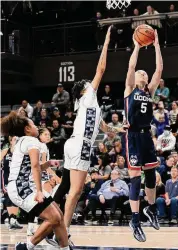  ?? Greg Fiume/Getty Images ?? UConn’s Paige Bueckers (5) drives to the basket in the third quarter against the Georgetown on Jan. 7.