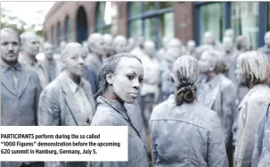  ??  ?? PARTICIPAN­TS perform during the so called “1000 Figures” demonstrat­ion before the upcoming G20 summit in Hamburg, Germany, July 5.