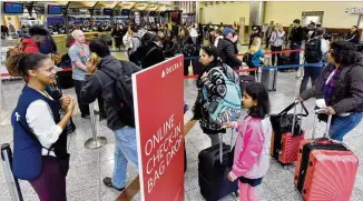  ?? HYOSUB SHIN / HSHIN@AJC.COM ?? Officials said peak wait times at Hartsfield-Jackson Internatio­nal Airport were about an hour and a half on Monday. Wait times were more manageable Tuesday, mostly under 30 minutes.
