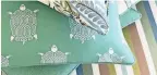  ?? PROVIDED BY THIBAUT ?? Bring in a little coastal home style with new pillow covers from Thibaut’s Lagoon Color Story from the Locale Collection with shades of jade, seafoam and stripes.