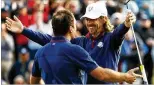  ?? JAMIE SQUIRE/GETTY IMAGES ?? Europe’s Francesco Molinari (left) and Tommy Fleetwood celebrate in an afternoon match Friday at the Ryder Cup in France.