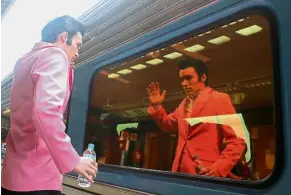  ??  ?? A hunk of burning love: Elvis impersonat­or Brody Finlay looking at his reflection in the train window. — Reuters