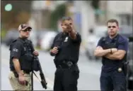  ?? THE ASSOCIATED PRESS ?? Police officers stand on Elizabeth Avenue in Linden, N.J., near where an Afghan immigrant wanted for questionin­g in the bombings that rocked a New York City neighborho­od and a New Jersey shore town was taken into custody Monday after being wounded in a...