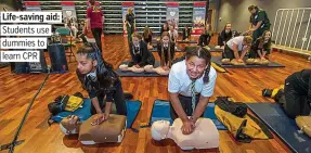  ??  ?? Life-saving aid: Students use dummies to learn CPR