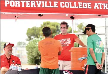  ?? RECORDER PHOTO BY CHIEKO HARA ?? New women’s cross country coach Brien Friedman, second from right, talks to visitors Wednesday, July 25, at a meet and greet event at Portervill­e College. The college added women’s cross country this fall.