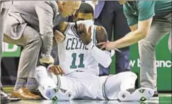  ?? AP ?? Kyrie Irving holds towel over face after being elbowed by own teammate and later exits Celtics’ 11th straight win Friday night.