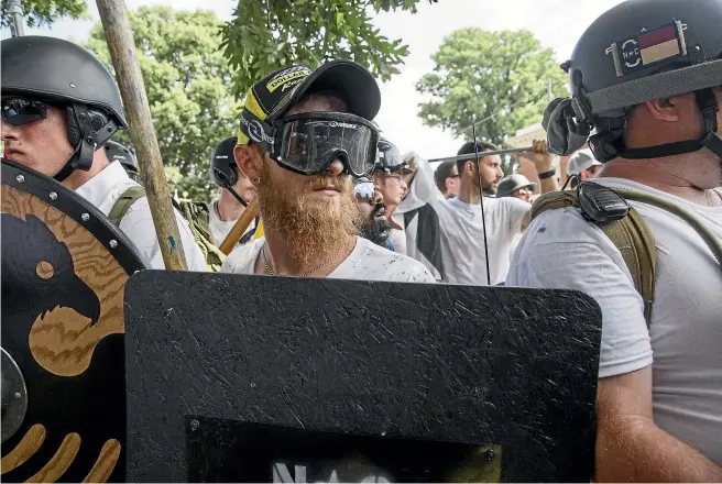  ?? GETTY ?? White supremacis­ts at a Unite the Right rally in Charlottes­ville, Virginia, in 2017 carried torches and chanted ‘‘You will not replace us’’ and ‘‘Jews will not replace us’’. The rally led to the killing of a rival protester by a Nazi sympathise­r.