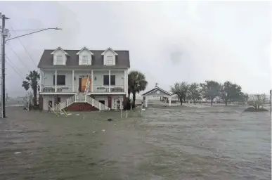  ??  ?? High winds and water surround a house Friday as Hurricane Florence hits Swansboro, N.C. TOM COPELAND / AP