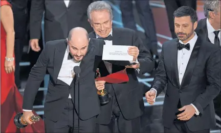  ??  ?? JORDAN HOROWITZ: La La Land producer reveals Moonlight is the true winner as Warren Beatty and host Jimmy Kimmel, right look on. Picture: Chris Pizzello