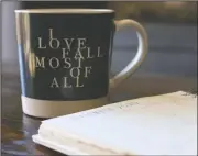  ?? (AP/Cheyanne Mumphrey) ?? Associated Press journalist Cheyanne Mumphrey opens her planner with a cup of hot chocolate in her studio in downtown Phoenix.
