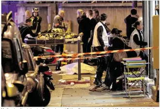  ?? MAXPPP / ZUMA PRESS ?? Medics stand by victims in a Paris restaurant Friday after a reported shootout.“As I speak, terrorist attacks of an unpreceden­ted scale are taking place in the Paris region,” French President Francois Hollande told the country in a nationally televised...