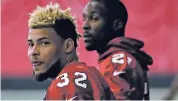  ?? ASSOCIATED PRESS FILE PHOTO ?? Arizona Cardinals’ Tyrann Mathieu, left, and Patrick Peterson watch drills during a minicamp June 6 in Tempe, Ariz. Mathieu rapidly establishe­d himself as one of the most dynamic defensive players in the NFL. But three injury-plagued seasons eroded his...