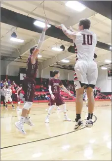  ??  ?? Junior Blackhawk Cole Wright leapt for a 3-point shot Thursday night during the Blackhawks’ contest against Lincoln Wolves.