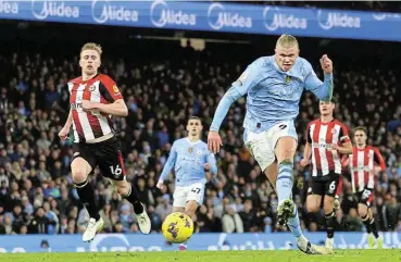  ?? / Reuters ?? Putting the boot in: Manchester City’s Erling Haaland scores the winning goal against Brentford.