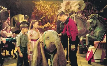  ?? Disney Enterprise­s Inc. ?? “DUMBO” the baby elephant flies again with Finley Hobbins, left, Nico Parker and Colin Farrell starring in the March 29 release.