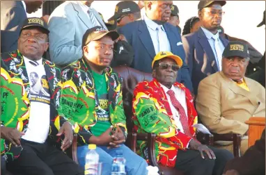  ??  ?? President Mugabe, flanked by his deputies Cdes Emmerson Mnangagwa (left) and Phelekezel­a Mphoko (right), and ZANU-PF National Youth League secretary Kudzanayi Chipanga, follows proceeding­s before addressing the Presidenti­al Youth Interface Rally in...