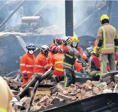  ??  ?? Left, fire and rescue workers at the scene of the blast at Bosley Mill.