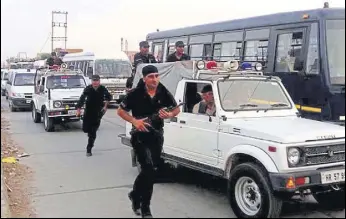  ?? MANOJ DHAKA/HT ?? Security forces during a flag march in Sirsa on Monday.