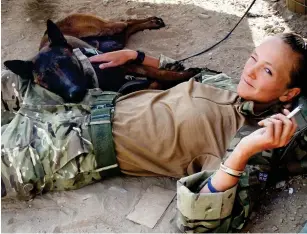  ??  ?? Saved lives: Kevin with handler Kelly Wolstencro­ft touring Afghanista­n