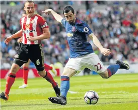  ?? /Reuters ?? Trophy life: Manchester United’s Henrikh Mkhitaryan scores their second goal against Sunderland at the weekend. The United striker is now targeting success in the Europa League.