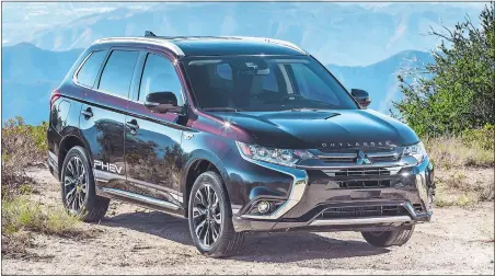  ??  ?? The Mitsubishi Outlander is now available as a plug-in hybrid that can run on electric power for up to 22 miles before its gasoline engine kicks in to extend the range.