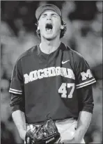  ?? Nati Harnik The Associated Press ?? Michigan pitcher Tommy Henry rejoices after finishing a complete-game shutout of Florida State at the College World Series on Monday in Omaha, Neb.