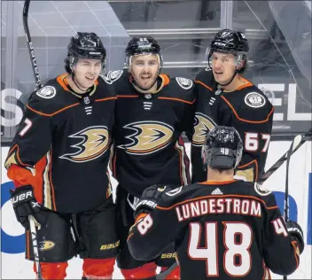  ?? LEONARD ORTIZ — STAFF PHOTOGRAPH­ER ?? The Ducks’ Kevin Shattenkir­k (22) is surrounded by teammates after scoring against the the Kings at Honda Center.