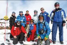  ??  ?? On a fine Saturday in a great snow season, Mt Mawson volunteer ski patrollers stop for a group shot, including Liz Koolhof and Simon Allen (third and fourth from left).