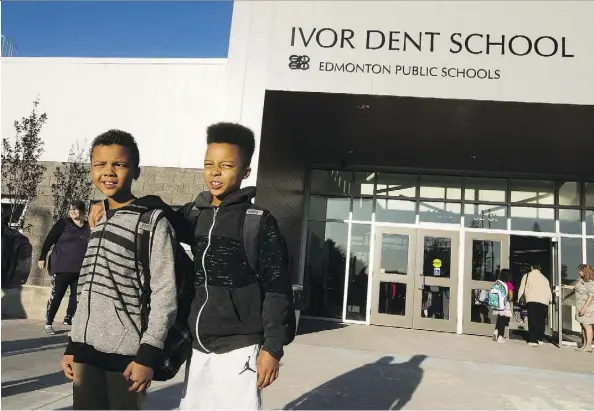  ?? GREG SOUTHAM ?? Noah Leigh-Modi, 11, and brother Zechariah, 12, prepare to enter the new Ivor Dent School for the first time Tuesday. Ivor Dent is one of 16 new schools opening this year in the city but, unlike new suburban schools, it replaces three aging school...