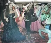  ?? NICK PROCAYLO/PNG ?? Julianna Lukan, left, tries on a dress with her mother Tracy Roy at the Cinderella Project’s 18th annual Boutique day on Sunday.