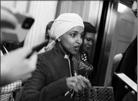  ?? JOSE LUIS MAGANA / ASSOCIATED PRESS ?? Rep. Ilhan Omar, D-minn., talks to reporters Thursday as she leaves the House chamber at the Capitol after House Republican­s voted to oust her from the House Foreign Affairs Committee. The vote, in a raucous session, was 218-211 along party lines, with one Republican voting present.