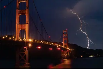  ?? KARL MONDON — STAFF ARCHIVES ?? Lightning flashes near the Golden Gate Bridge in August 2020in a view from San Francisco. The iconic structure has been undergoing seismic retrofitti­ng work since 1997follow­ing the magnitude 8.3Loma Prieta earthquake in 1989.