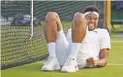  ?? TIM IRELAND/THE ASSOCIATED PRESS ?? Jo-Wilfried Tsonga of France slips against Sam Querrey of the United States on Friday at Wimbledon in London. The players have been complainin­g about the condition of the courts.