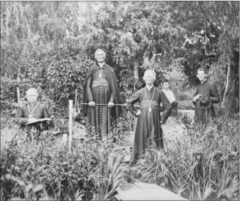  ?? COURTESY OF THE PALACE OF THE GOVERNORS PHOTO ARCHIVES ?? Archbishop Jean-Baptiste Lamy, second from left, with the first bishop of Denver, J.P. Machebeuf, third from left, in the archbishop’s garden in Santa Fe in 1880. Lamy, the initial bishop of Santa Fe after New Mexico became a U.S. territory in 1848, sought to reform Catholicis­m in the region away from Indigenous- and Spanish-influenced folk traditions and played a leading role in the funding and constructi­on of the Cathedral Basilica of Saint Francis of Assisi.