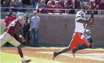  ??  ?? THAT’S SIX: Miami’s Jeff Thomas gets behind the Florida State defense for a touchdown.