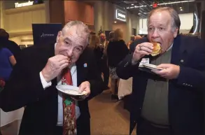  ?? Erik Trautmann / Hearst Connecticu­t Media file photo ?? Lou DePanfilis and John Lindgren enjoy sliders from the Dry Dock during the second annual Cooking for Charity on Nov. 29, 2018, at Aitoro Appliance in Norwalk.