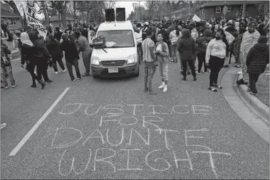  ?? CHRISTIAN MONTERROSA/AP PHOTO ?? People gather in protest Sunday in Brooklyn Center, Minn. The family of Daunte Wright, 20, told a crowd that he was shot by police Sunday before getting back into his car and driving away, then crashing the vehicle several blocks away. The family said Wright was later pronounced dead.