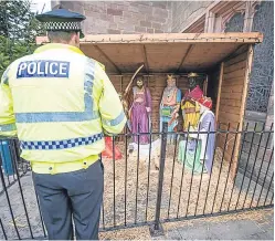  ?? Pictures: Deadline News/Police Scotland. ?? The life-size doll was snatched from the traditiona­l manger scene outside St John’s Kirk on Monday night. Above, right: two police officers with the recovered doll and baby lamb.