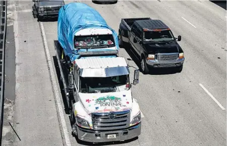  ?? CARLINE JEAN/SUN SENTINEL ?? The van believed to be owned by bombing suspect Cesar Sayoc Jr., 56, of Aventura, is transferre­d to the FBI Headquarte­r in Miramar on Friday.