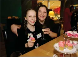  ??  ?? Young finalist Grace Warnock, 12, enjoys a cake with mum Judith