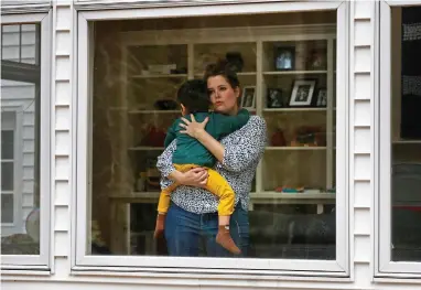  ??  ?? ASSOCIATED PRESS
In this Wednesday, April 1, 2020 photo, Joy Engel holds her son at her home in Cape Elizabeth, Maine. Engel, who is pregnant, and her husband, Dr. Ben Hagopian, who works at a family practice and an urgent care clinic, decided to isolate themselves from each other since the coronaviru­s outbreak.