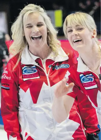  ?? PAUL CHIASSON/THE CANADIAN PRESS ?? Canada’s Jennifer Jones and Dawn McEwen are all smiles despite struggling to a 9-5 win over China on Monday to improve to 4-0 at the world championsh­ip tournament in North Bay, Ont.