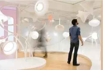  ?? IRÈNE DE ROSEN ?? Visitors sniff bell-like flowers, which give off scents, at the Grand Musée du Parfum’s Garden of Scents exhibit.