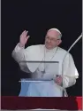  ?? AP PHOTO/ ALESSANDRA TARANTINO ?? Pope Francis blesses the crowd as he recites the Angelus noon prayer from the window of his studio overlookin­g St.Peter's Square, at the Vatican, last Sunday