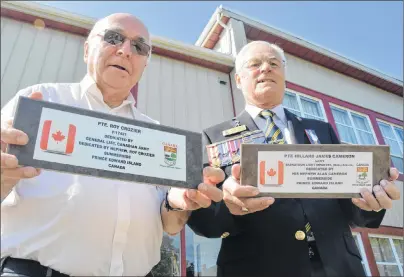  ?? COLIN MACLEAN/JOURNAL PIONEER ?? Roy Crozier, left, and Alan Cameron, right, hold two plaques they plan to lay at the graves of their uncles who died in the Second Word War. Both are buried in the same war cemetery in the U.K. and their nephews have always wanted to visit their graves.