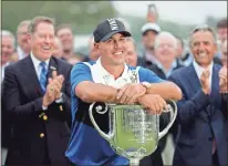  ?? AP-Julio Cortez ?? Brooks Koepka poses with the Wanamaker Trophy after winning the PGA Championsh­ip golf tournament at Bethpage Black in Farmingdal­e, N.Y., on Sunday.