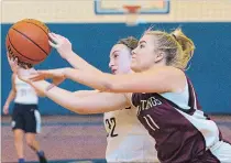  ?? JULIE JOCSAK
THE ST. CATHARINES STANDARD ?? Josee Severin of the St. Paul Patriots and Julie Manlow of the Saint Michael Mustangs fight for the ball.