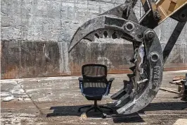  ?? BRYAN ANSELM / THE NEW YORK TIMES ?? The jaws of an excavator that is about to mangle an office chair for disposal at a recycling center in Queens, New York, last month. With plenty of office space still available post-pandemic in the New York metro area, and failures by companies to pay storage fees mounting, liquidator­s and resellers can’t keep up with the glut of office furniture — and much of it is simply being destroyed.