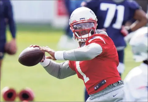  ?? Steven Senne / Associated Press ?? New England Patriots quarterbac­k Cam Newton winds up for a pass during practice on Wednesday in Foxborough, Mass.